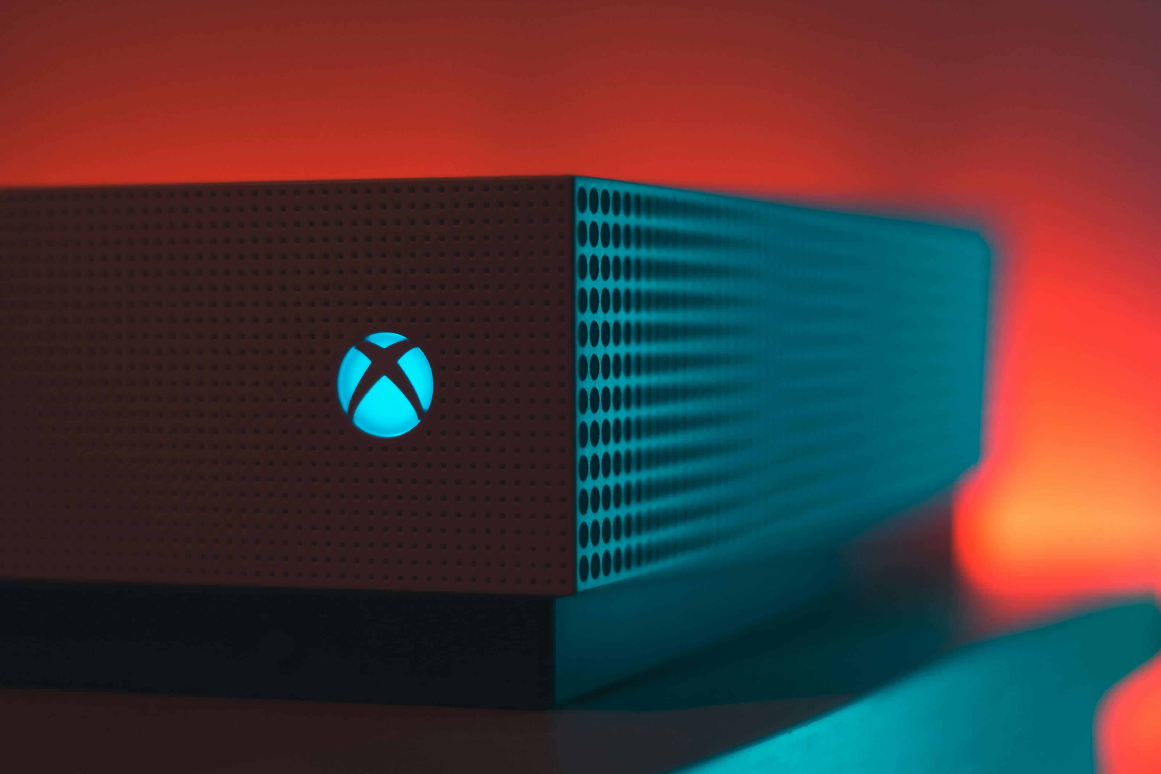Xbox One S console with cinematic red and teal lighting
